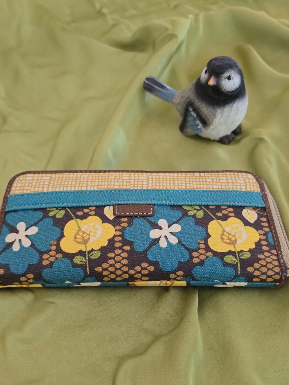 Fossil Key-Per zip-around wallet featuring a brown, yellow, and blue floral patt